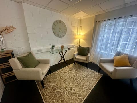 Interior of the Bromley therapy room — armchairs, soft lighting and a calm, welcoming space